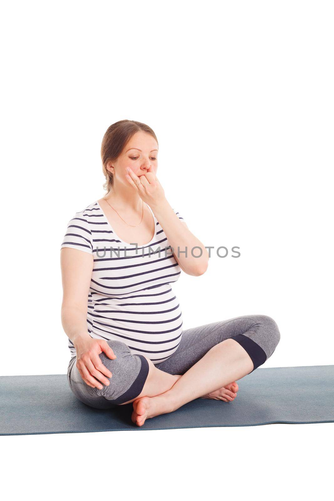 Pregnant woman doing yoga breathing exercise Pranayama by dimol