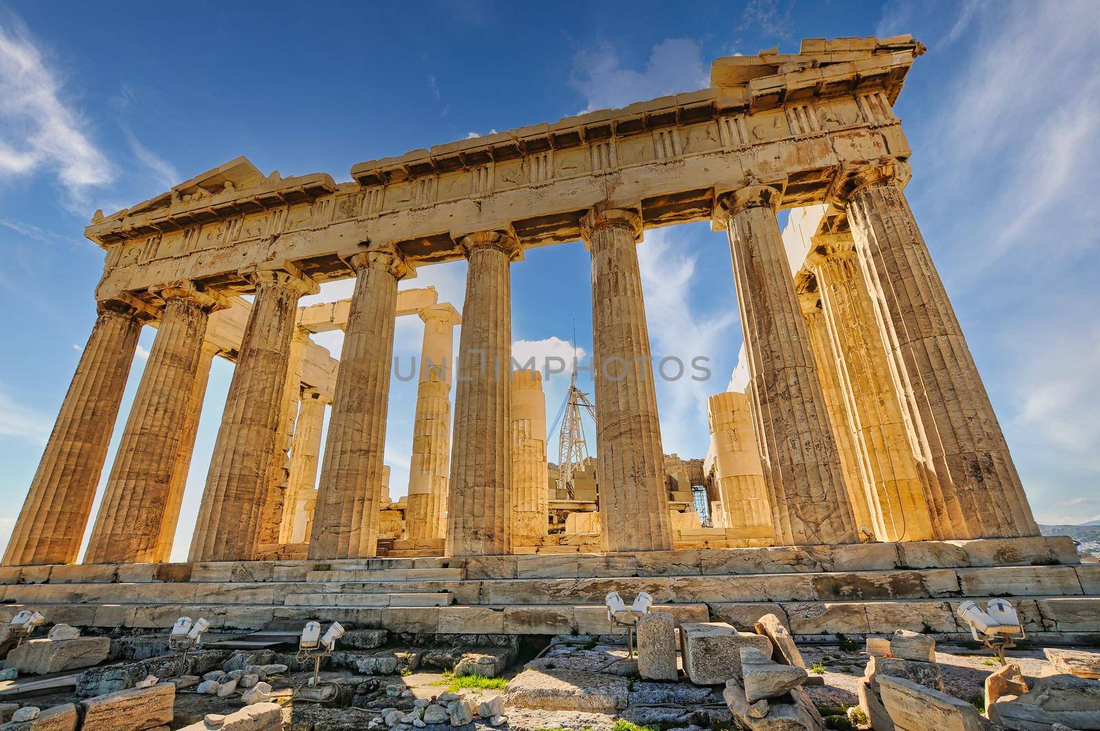 The Acropolis of Athens, Greece, with the Parthenon Temple on top of the hill during a summer sunset..