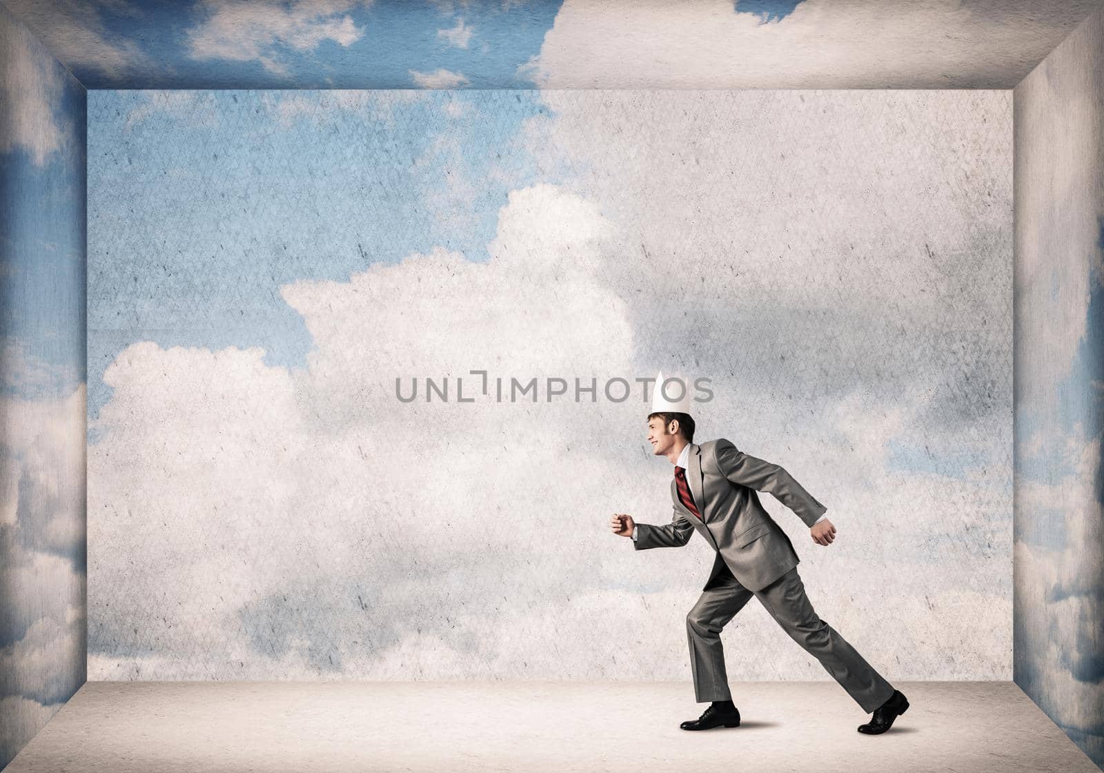 King businessman in elegant suit running in empty room with blue sky on wall by adam121