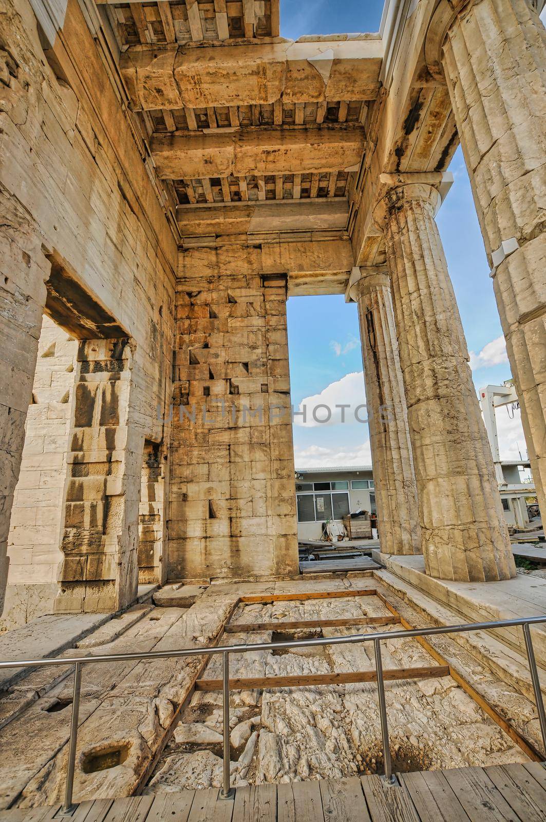 "Propylaea" the entrance of Acropolis illuminated by dramatic fiery sunny sky, Athens Greece