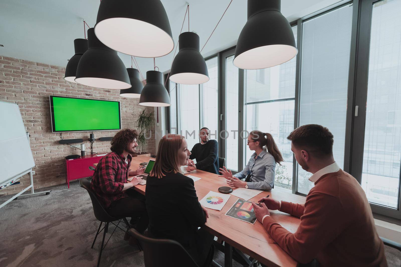 Successful team. Group of young multi-ethnic business people working and communicating together in creative office. Selective focus by dotshock