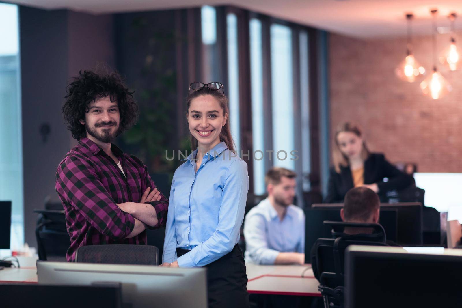 Two happy diverse professional executive business team people woman and man looking at camera standing in office lobby hall. Multicultural company managers team portrait. High-quality photo