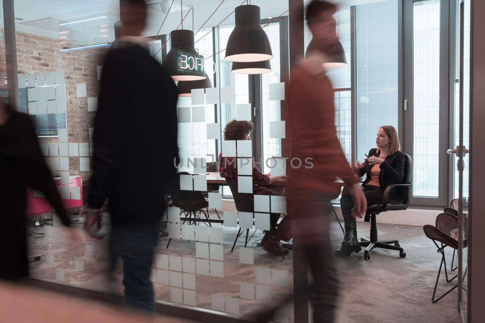 Successful team. Group of young business people working and communicating together in creative office. Selective focus. High-quality photo