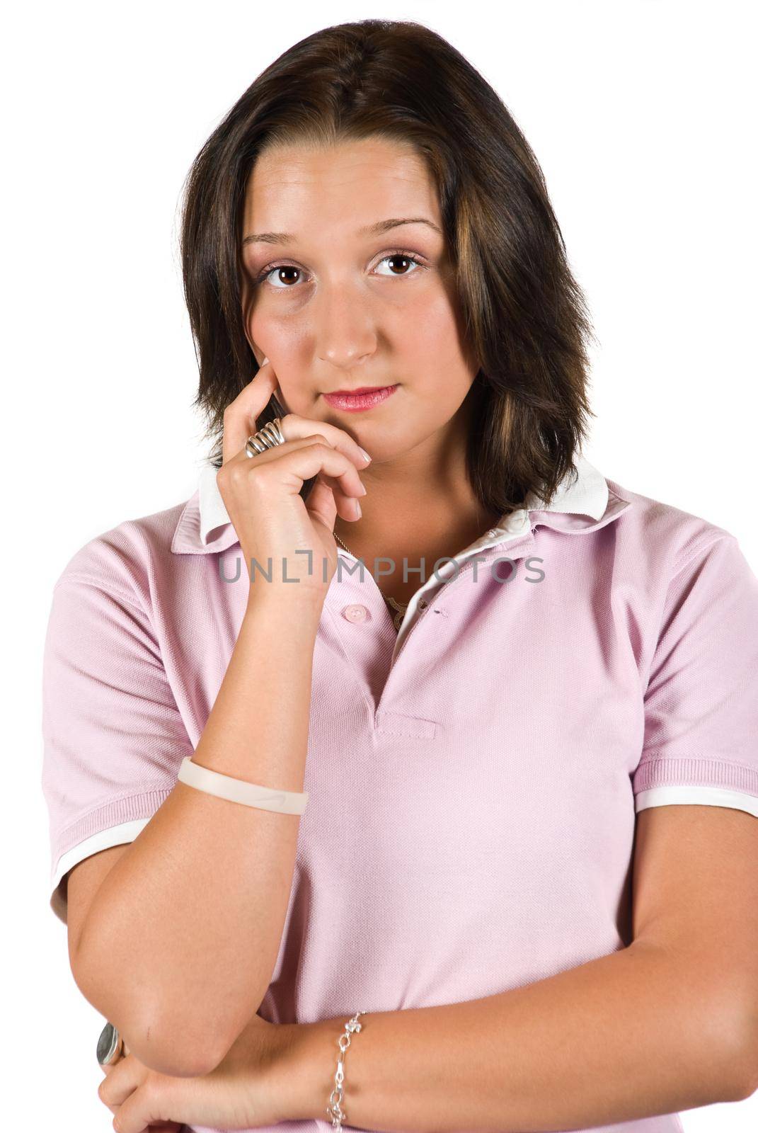 Sad teenager female looking at you and standing with hand to chin isolated on white background