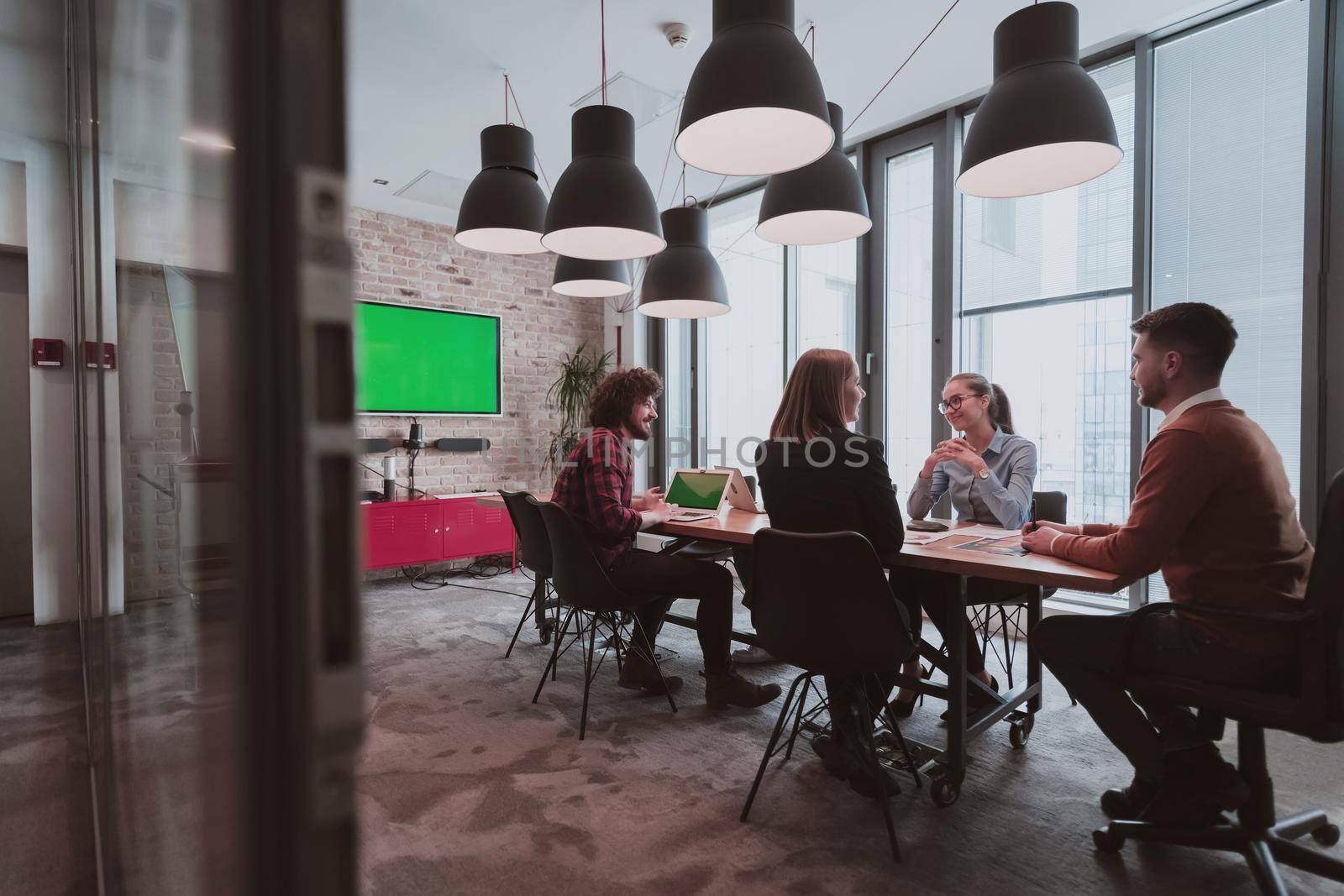 Successful team. Group of young multi-ethnic business people working and communicating together in creative office. Selective focus by dotshock