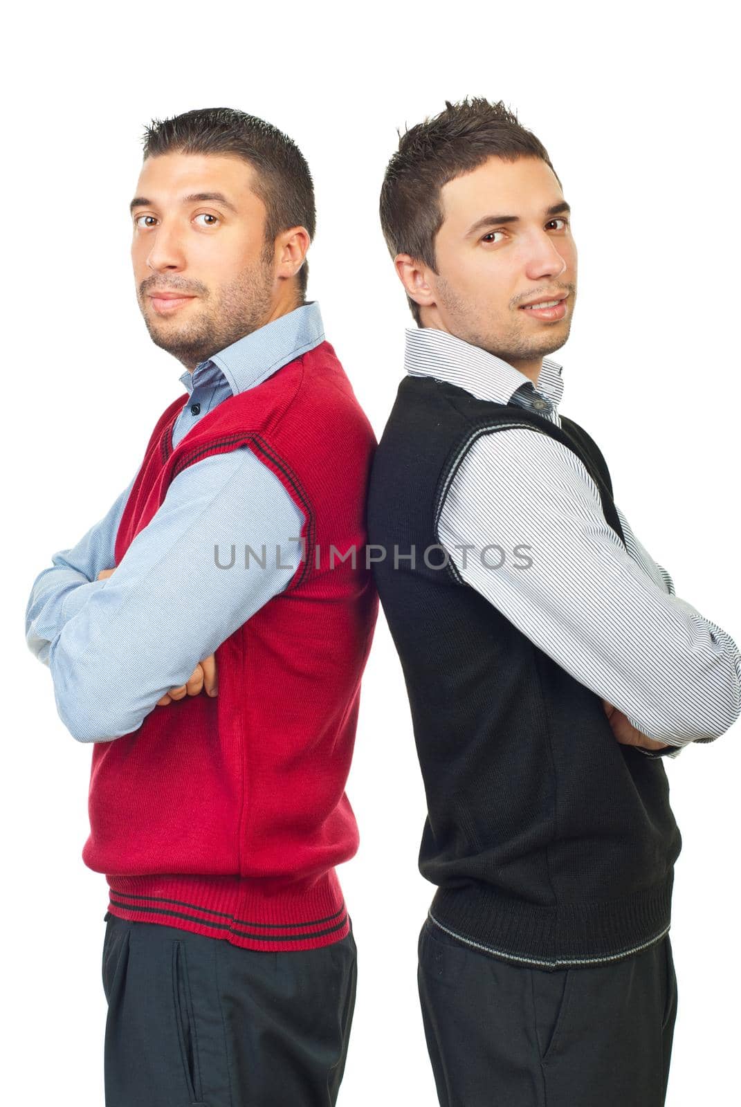 Two business men team standing back to back with hands crossed wearing shirts and vests isoalted on white background