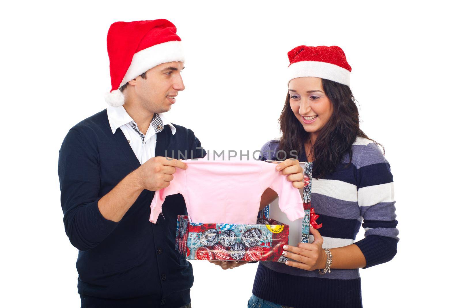 Happy couple  open a gift and receiving surprising news at Christmas by  found a baby cloth in box,they will be parents