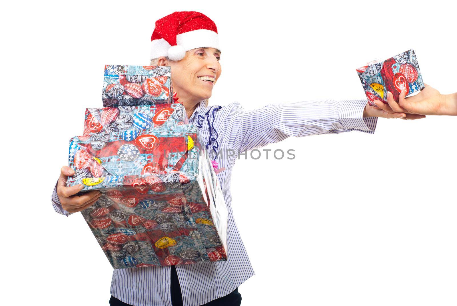 Senior woman holding Christmas presents by justmeyo