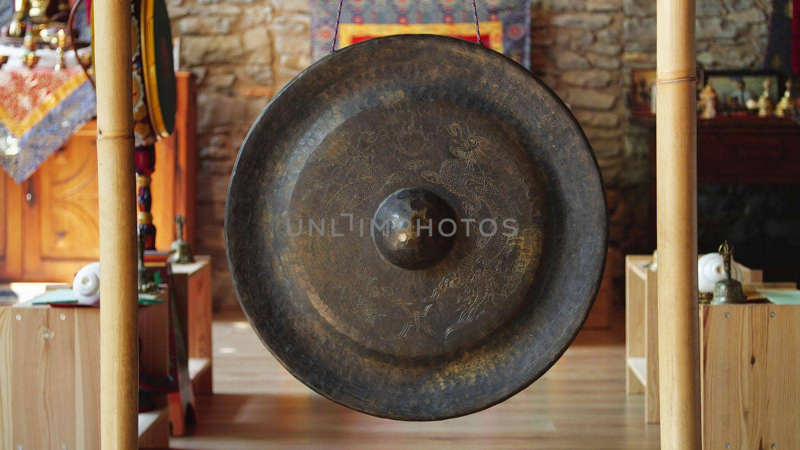 Asian religious metal gong to alert monks of prayer time - religion, tradition and lifestyle concept by apavlin