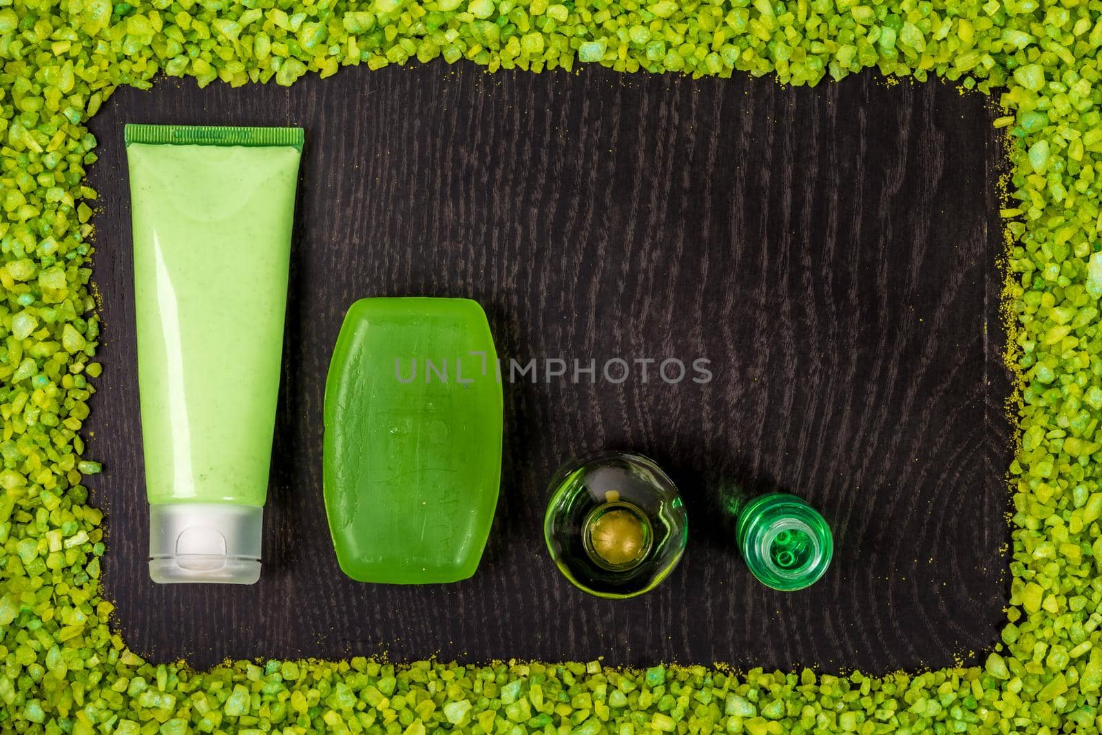 Cosmetic hygienic products on wooden background. Frame of salt. Still life. Top view. Copy space