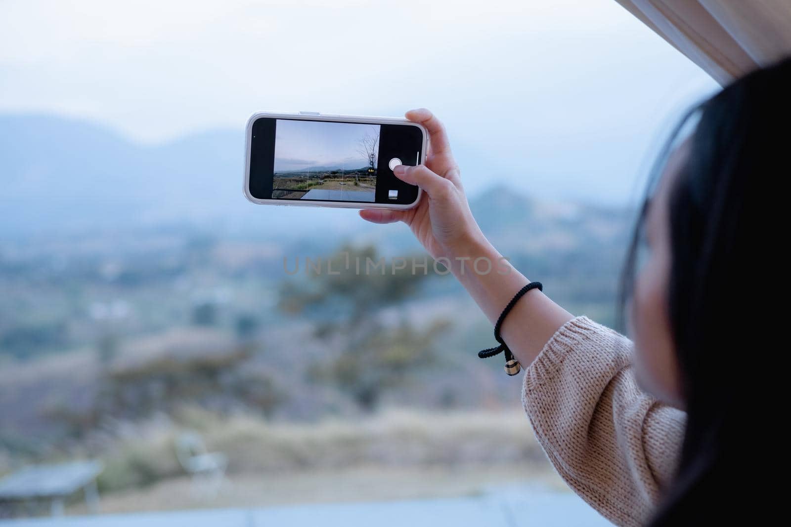 Woman using smartphone take a photo at Khao Kho, Thailand by iPixel_Studio