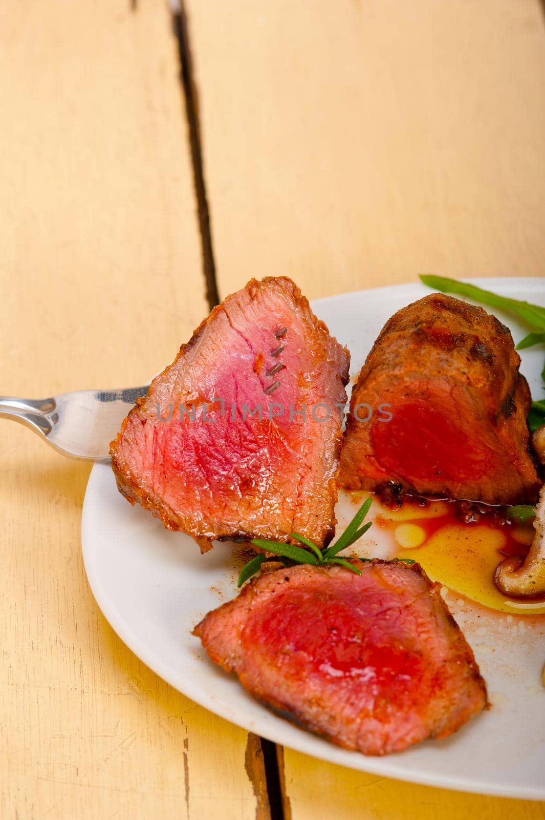 beef filet mignon grilled with fresh vegetables on side ,mushrooms tomato and arugula salad