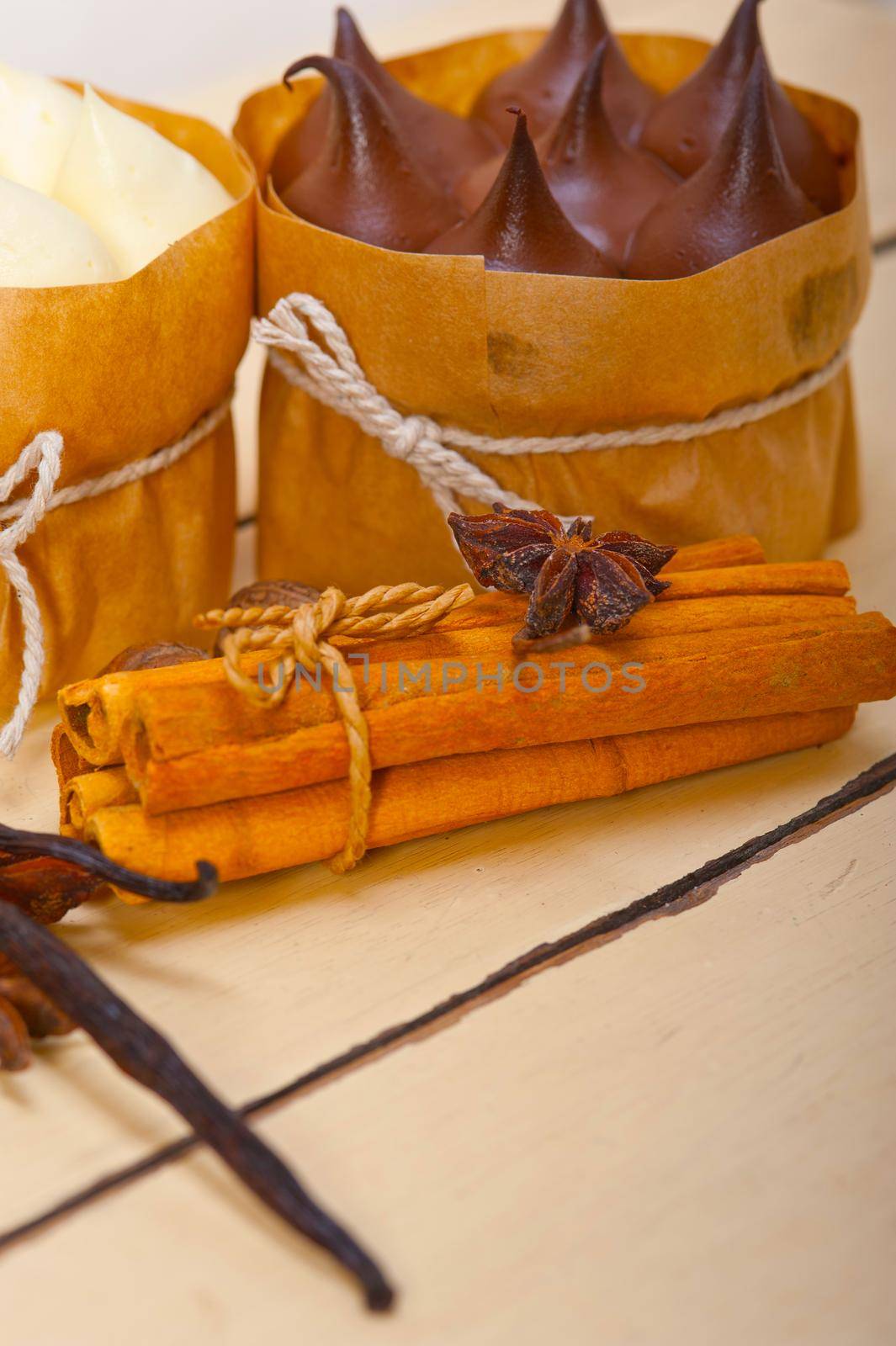 fresh baked chocolate vanilla and spices cream cake dessert over rustic wood table 