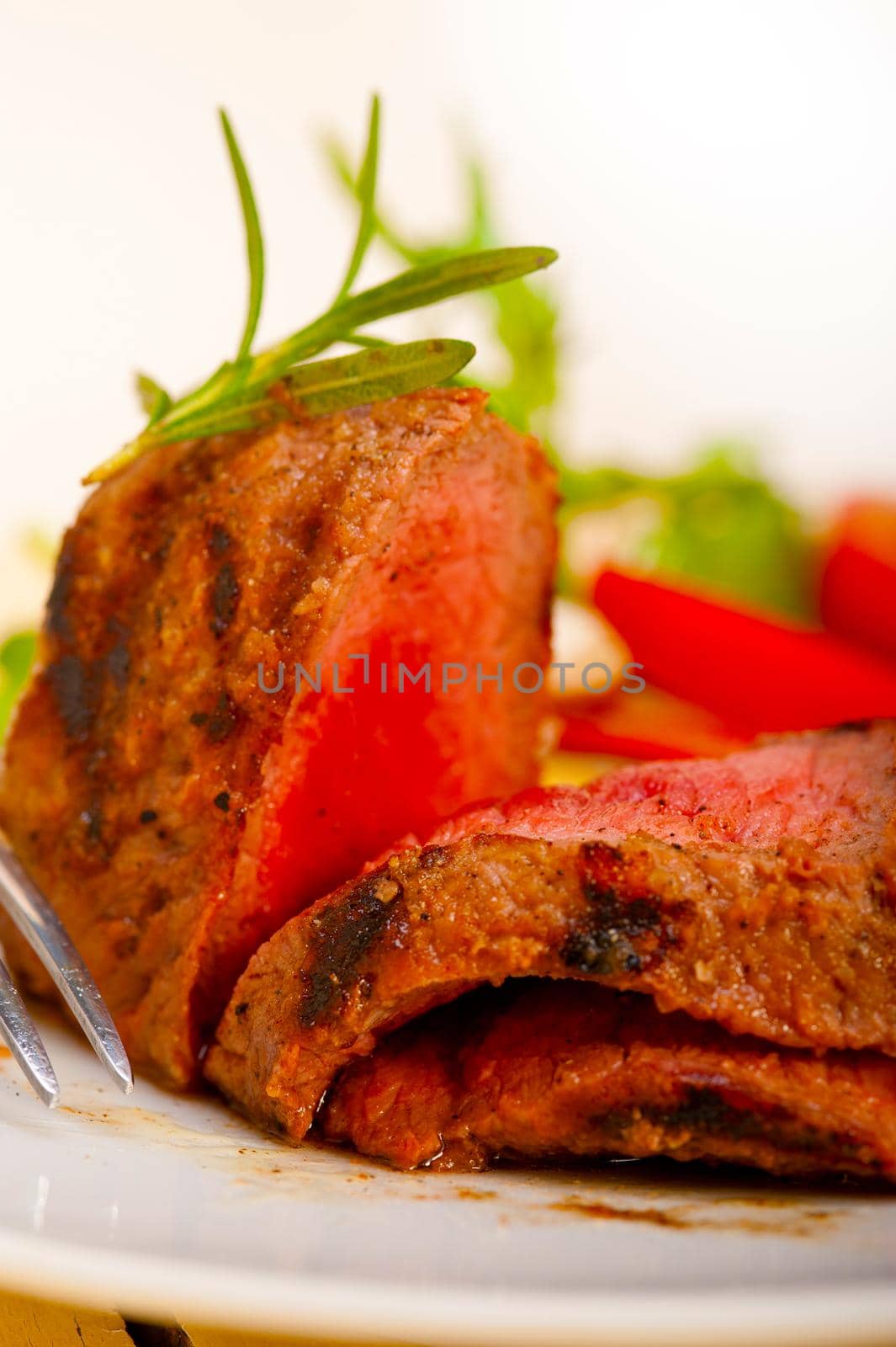 beef filet mignon grilled with fresh vegetables on side ,mushrooms tomato and arugula salad