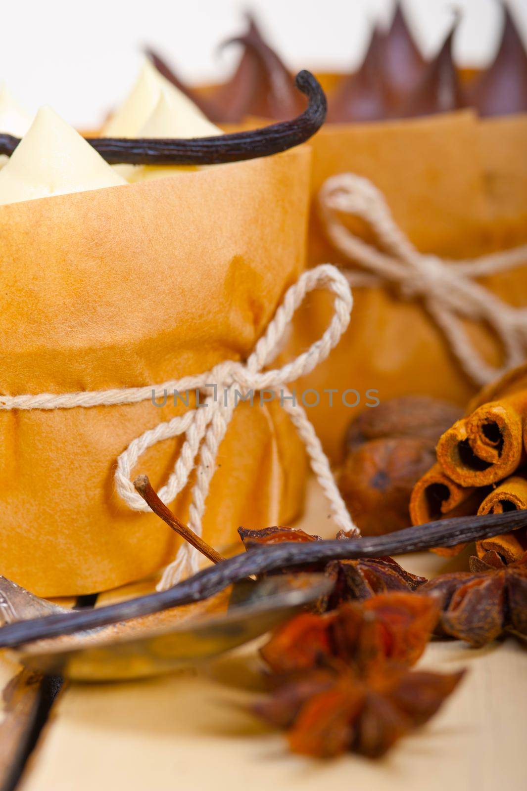 fresh baked chocolate vanilla and spices cream cake dessert over rustic wood table 