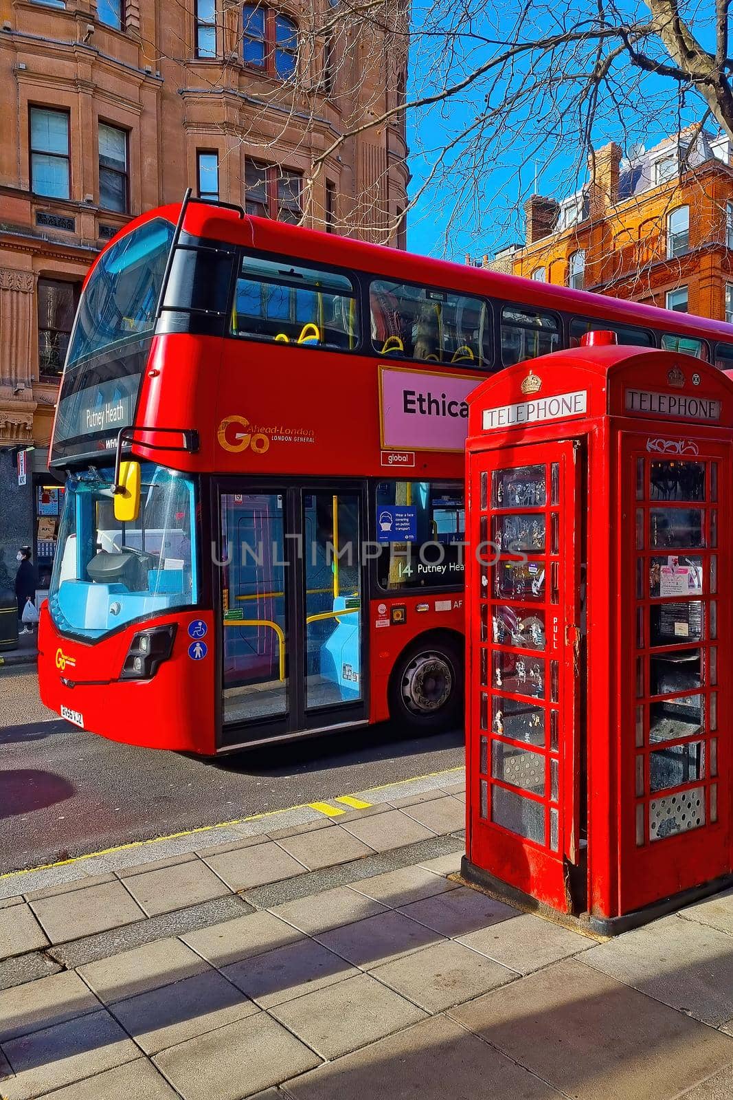 London, United Kingdom, February 8, 2022: the famous red double-decker bus and the red telephone booth on a London street. by kip02kas