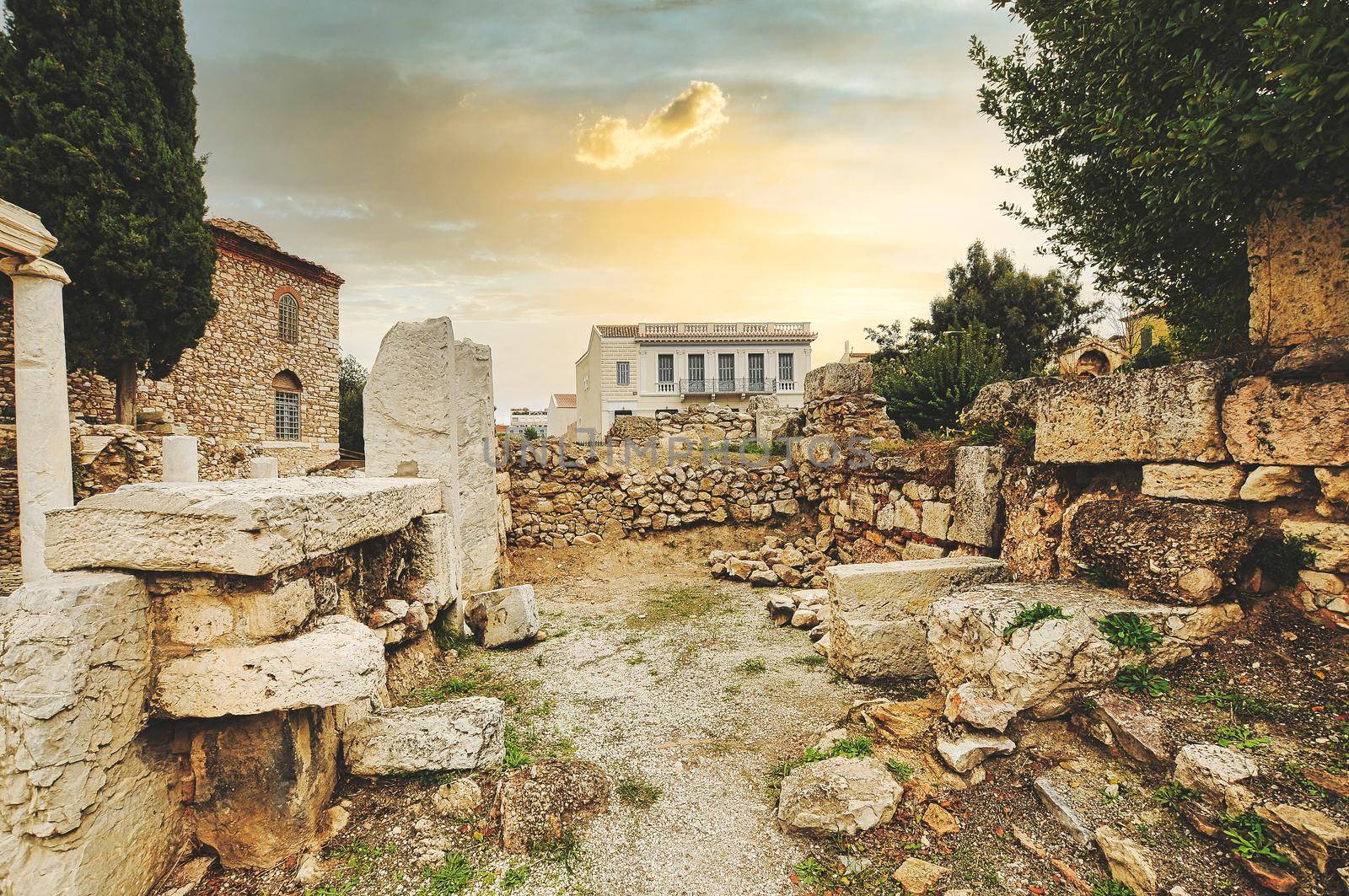 Evening light illuminates ancient ruins inside Roman Agora, Athens, Greece