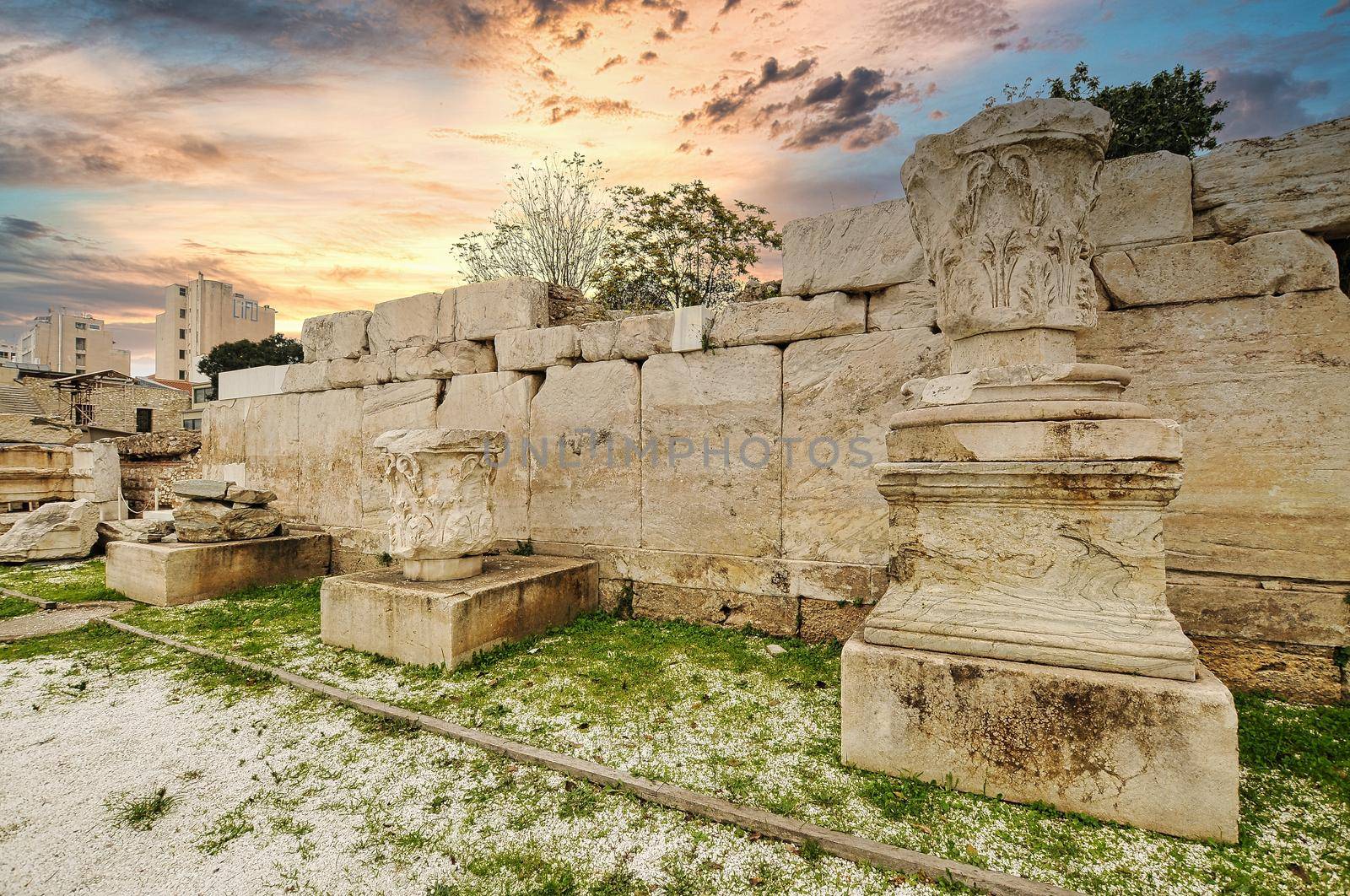 Panoramic view of the Library of Hadrian, Athens, Greece. It is one of the main landmarks of Athens. Scenery of Athens city center with Ancient Greek ruins. Famous Acropolis of Athens in the distance.