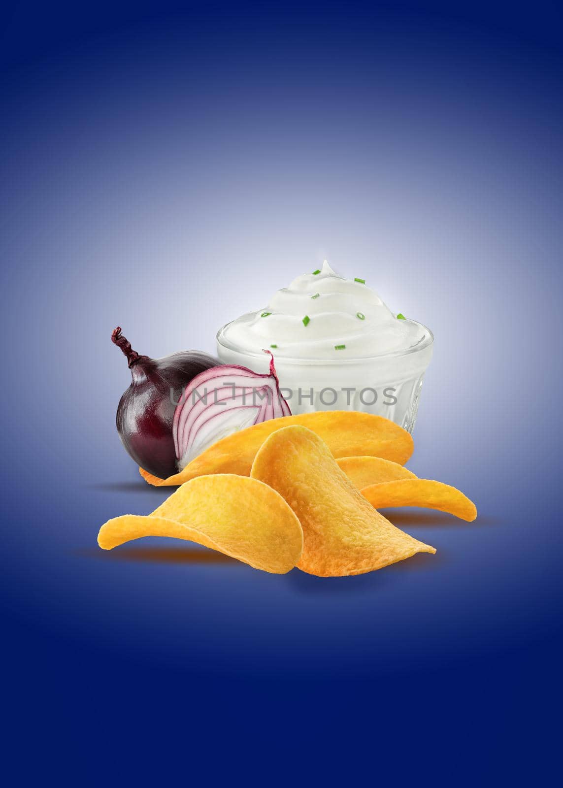 Red onion bulb and a half, sauce with green onion and chips or crisps on a blue background with copy space for text or images. Advertising. Close-up. by nazarovsergey