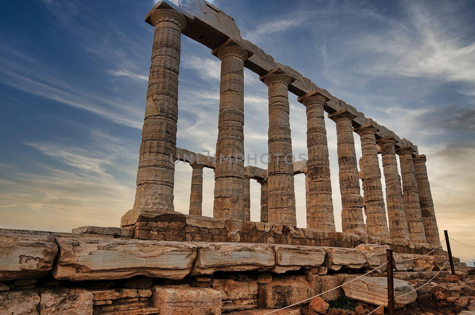 Greece. Cape Sounion - Ruins of an ancient Greek temple of Poseidon before sunset by feelmytravel