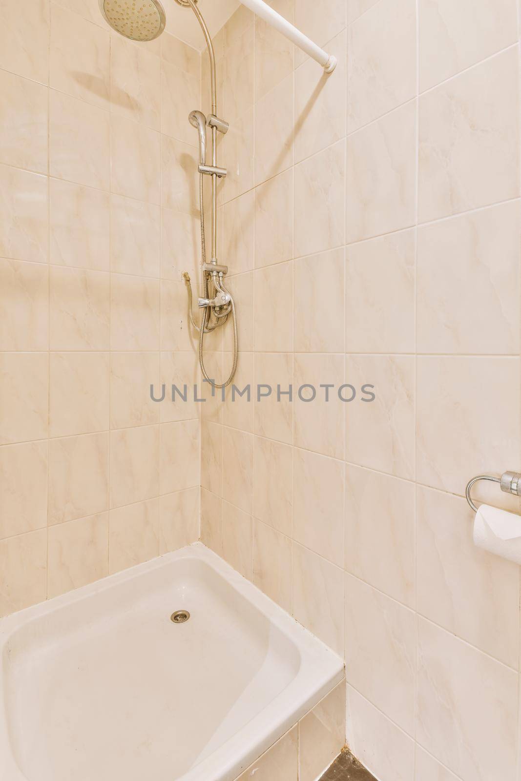 Open shower in gray tiled room by casamedia