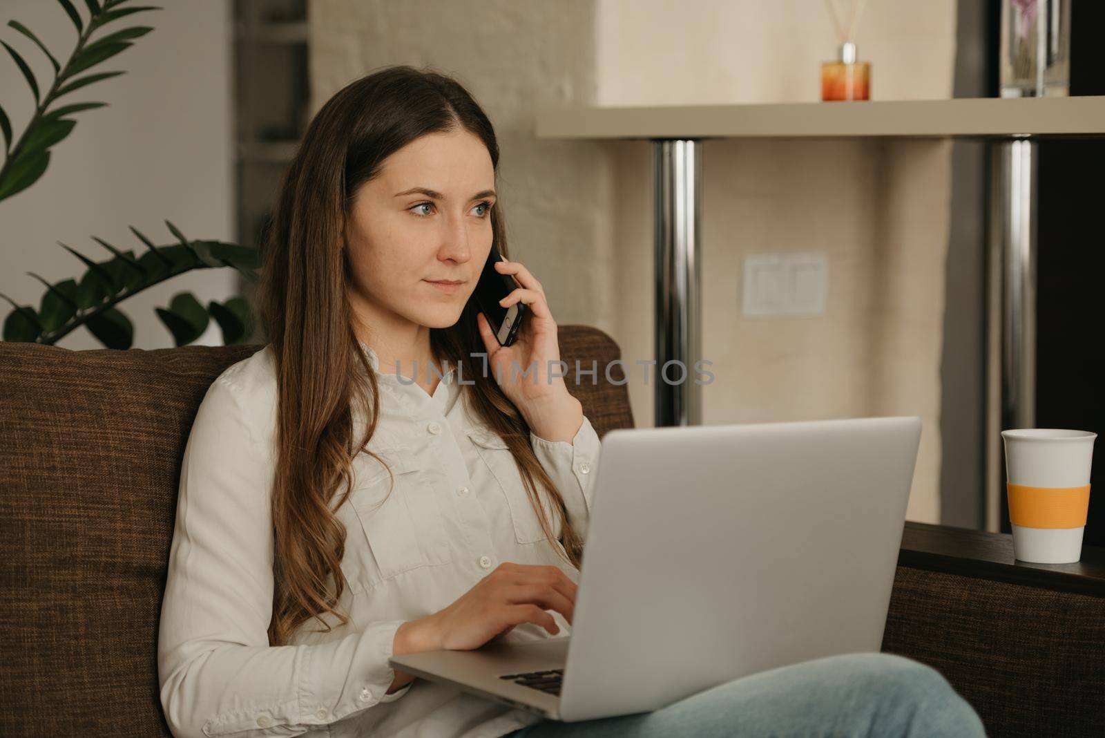 Remote work. A caucasian woman working remotely on her laptop. A businesswoman calling to her business partner from home.