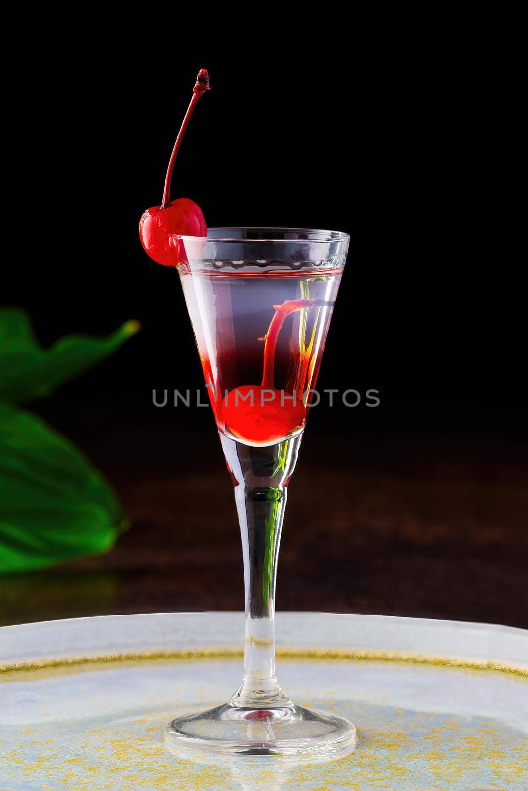 cherry liqueur and vodka cocktail with berry on wooden table. by PhotoTime