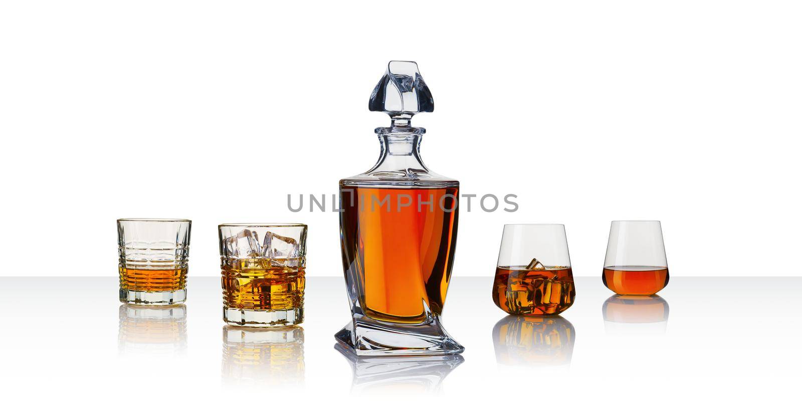 Decanter with whiskey and whiskey glasses. Carafe and glass of whiskey on a white background. Banner with copy space