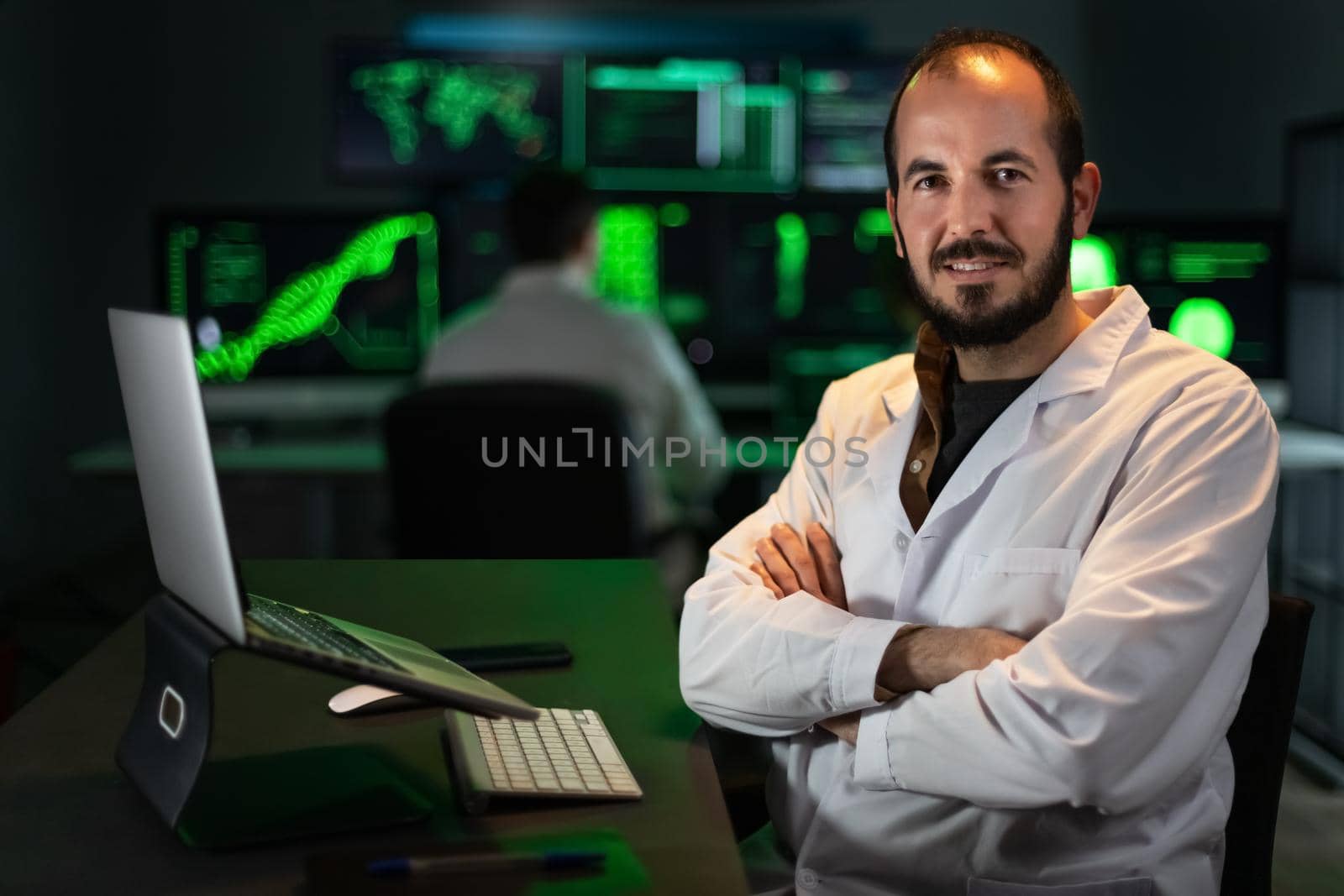 Portrait of happy scientist doctor wearing white coat in the office, looking at camera. Copy space. by Hoverstock