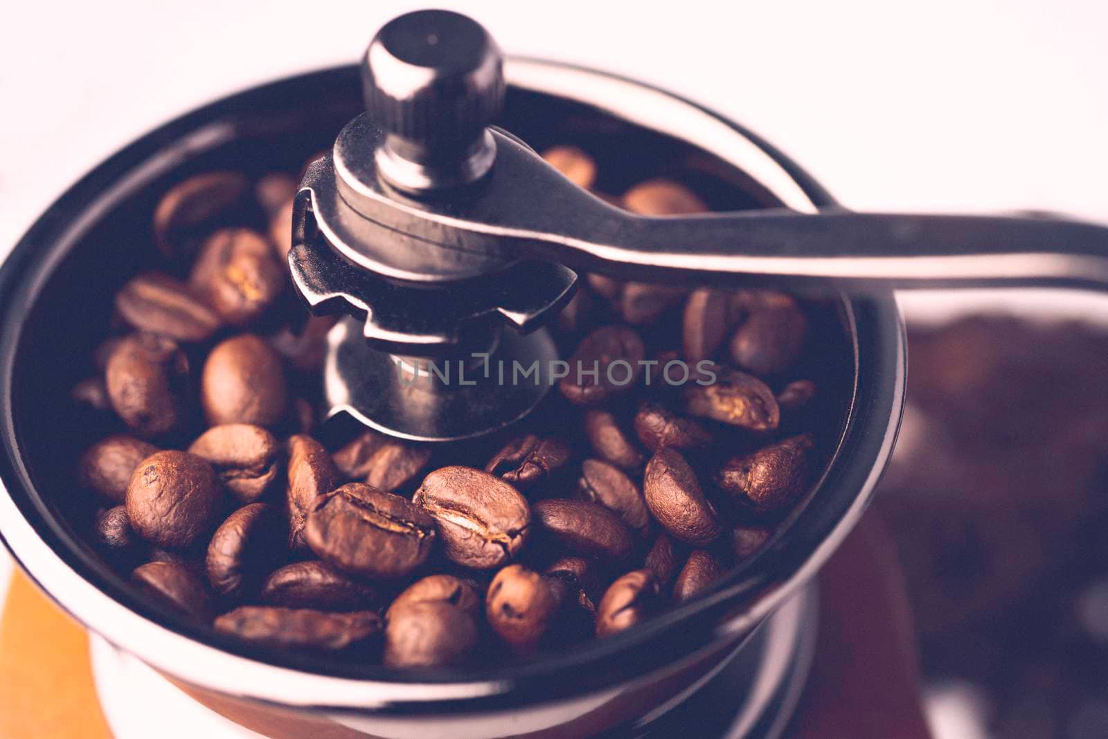 Coffee bean roasted in wooden grinder.