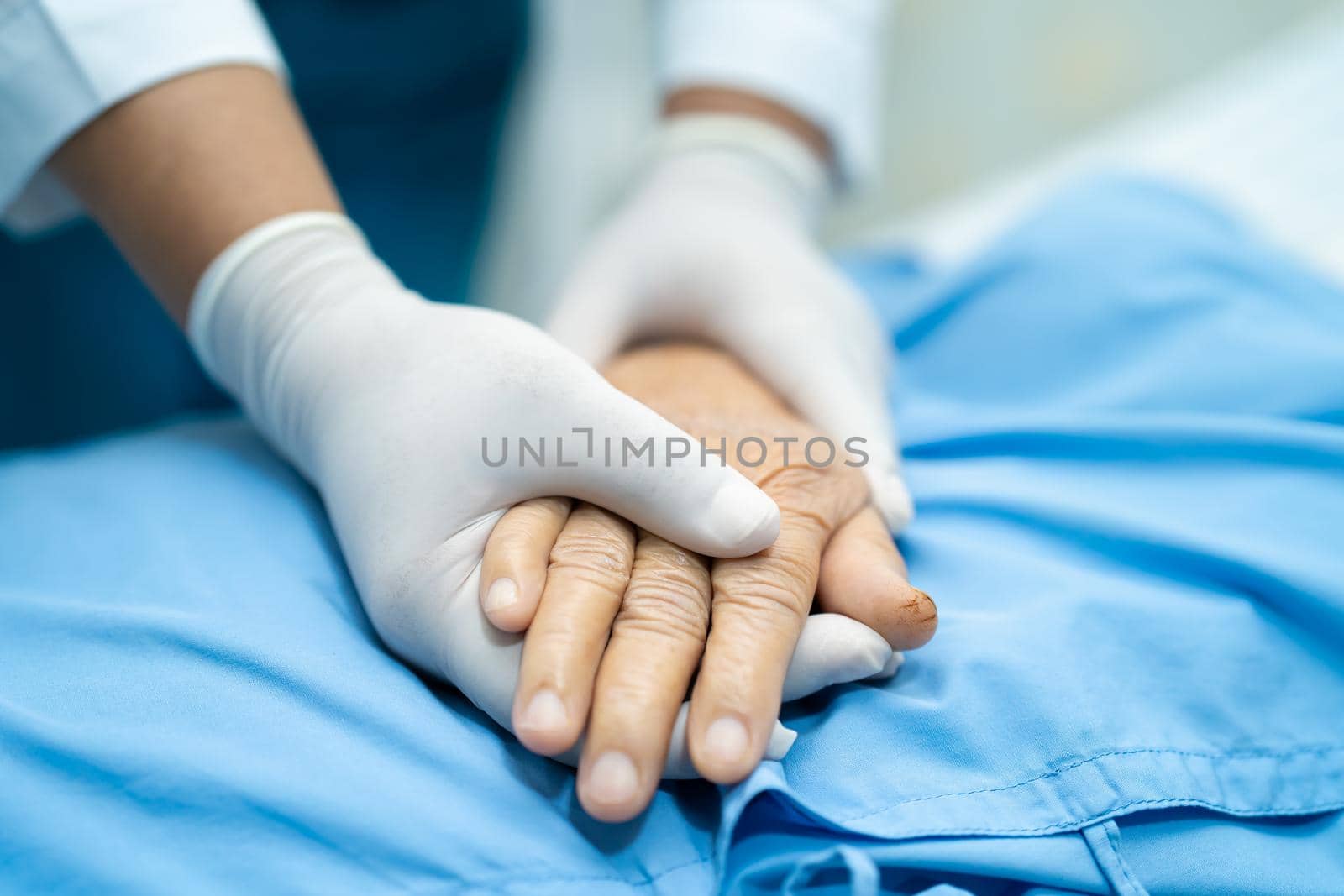 Holding hands Asian senior or elderly old lady woman patient with love, care, encourage and empathy at nursing hospital ward, healthy strong medical concept by pamai