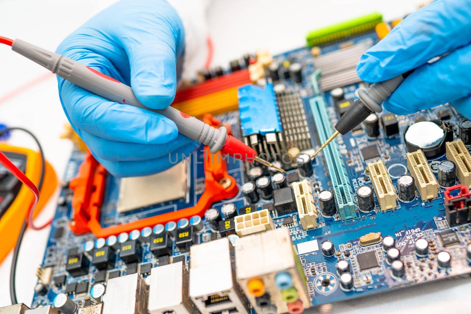 technician repairing inside of hard disk by soldering iron. Integrated Circuit. the concept of data, hardware, technician and technology. by pamai