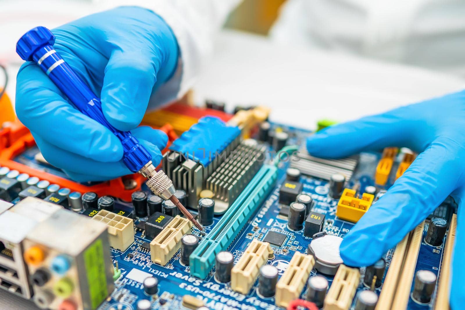 Technician repairing inside of hard disk by soldering iron. Integrated Circuit. the concept of data, hardware, technician and technology. by pamai