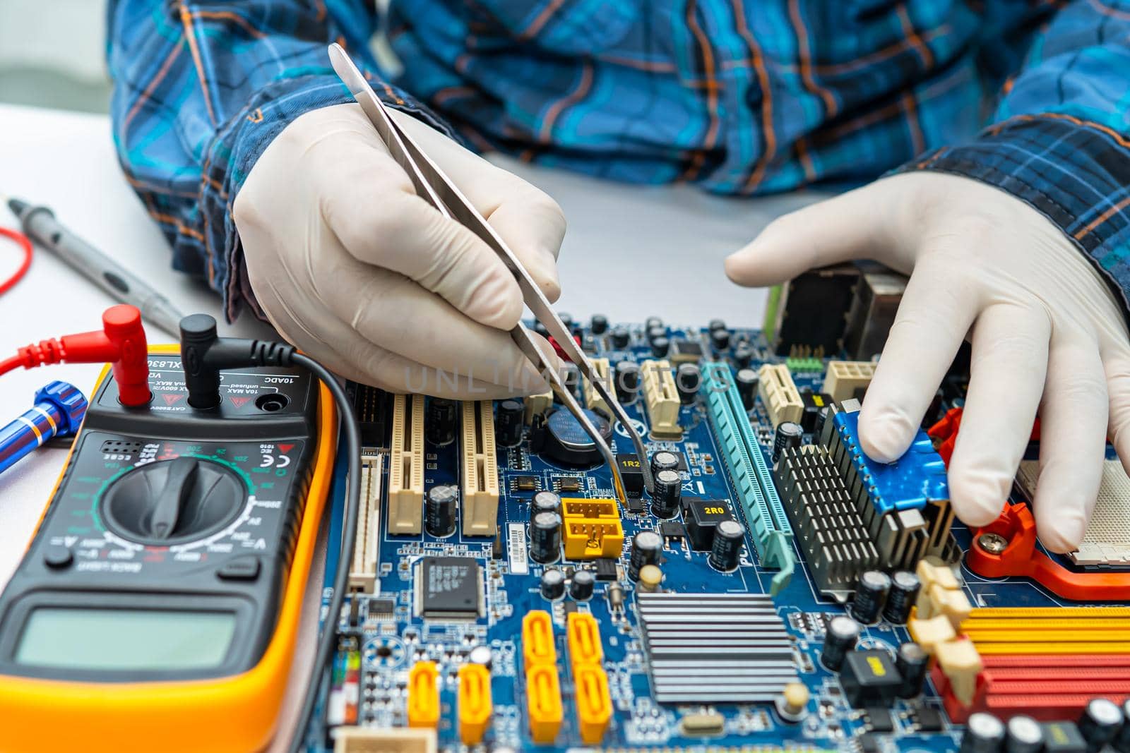 technician repairing inside of hard disk by soldering iron. Integrated Circuit. the concept of data, hardware, technician and technology.