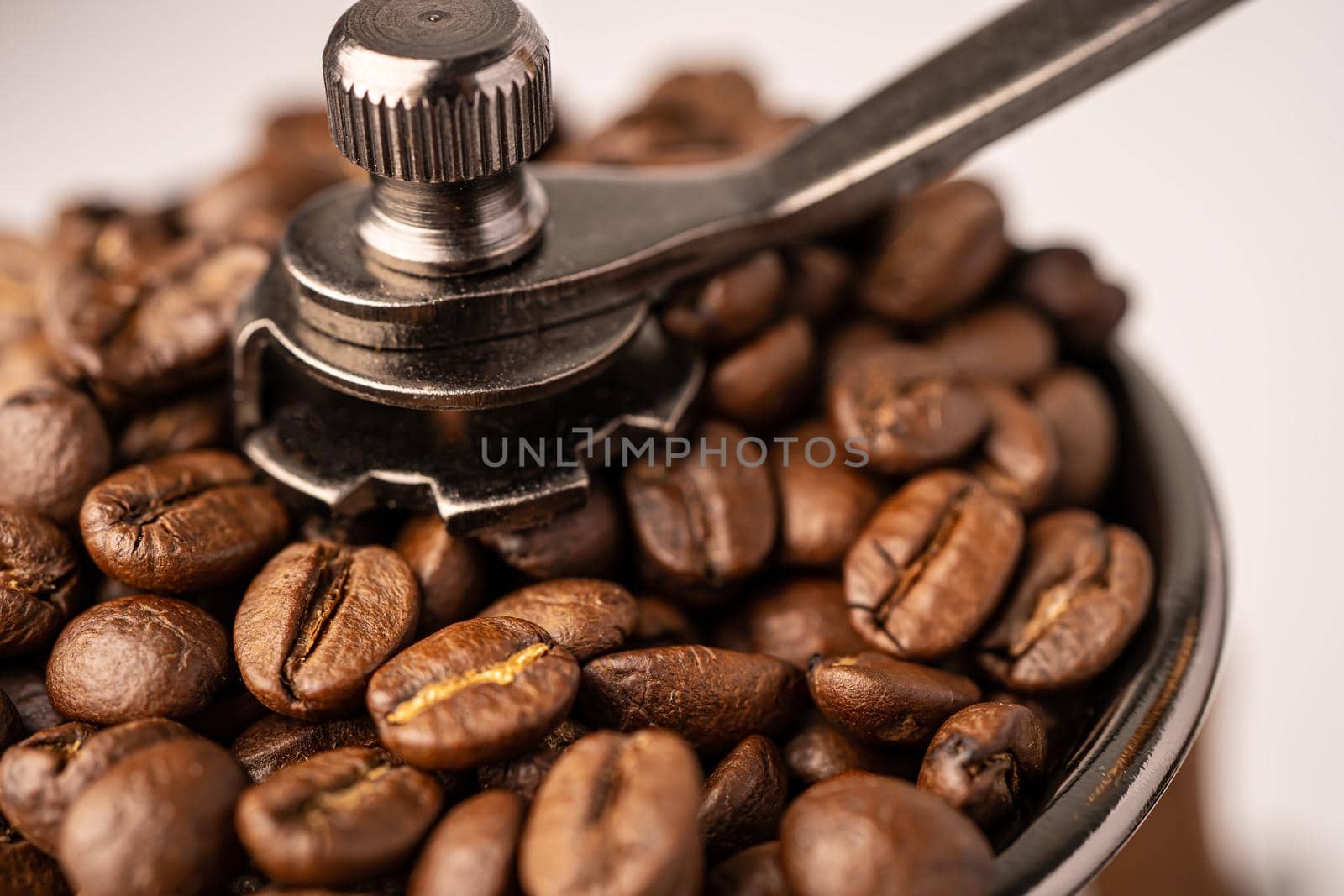 Coffee bean roasted in wooden grinder.