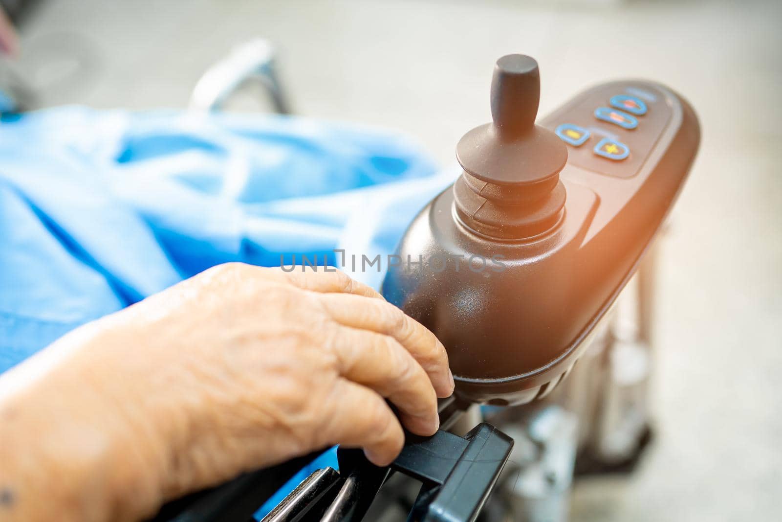 Asian senior or elderly old lady woman patient on electric wheelchair with remote control at nursing hospital ward, healthy strong medical concept