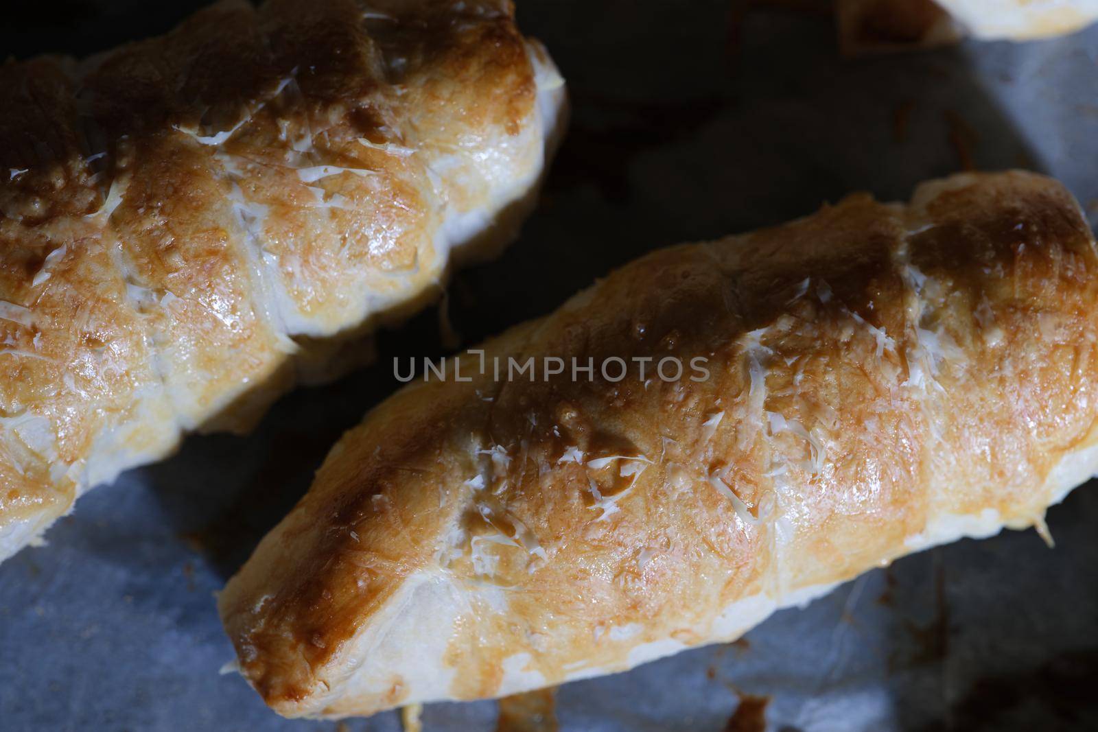 Freshly cooked sausage in dough in sauce closeup by kuprevich