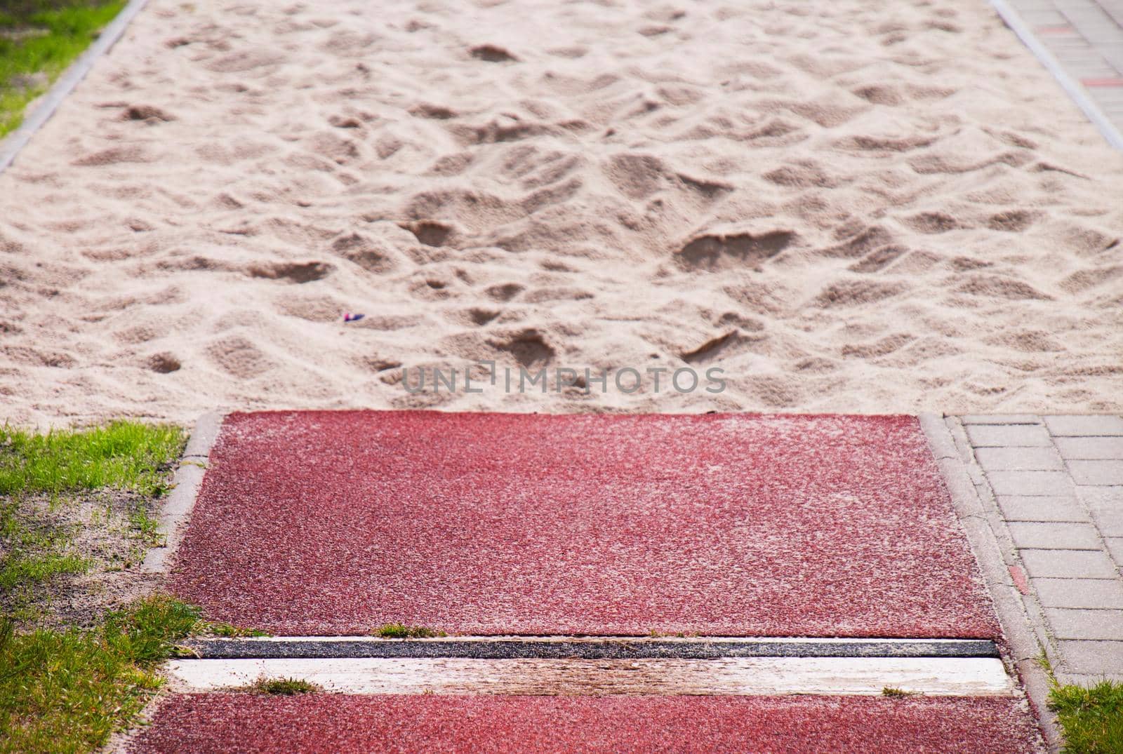 Long jump sand box in athletic stadium.