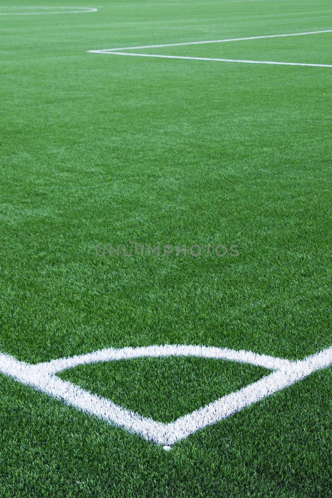 White corner line on green football field