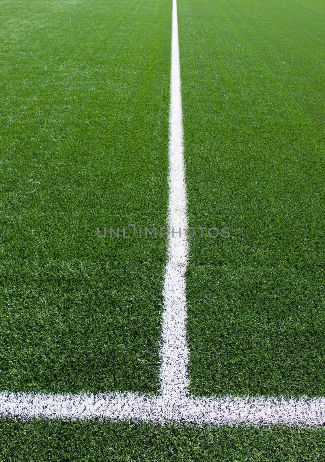 White line cross on green football field by rdonar2