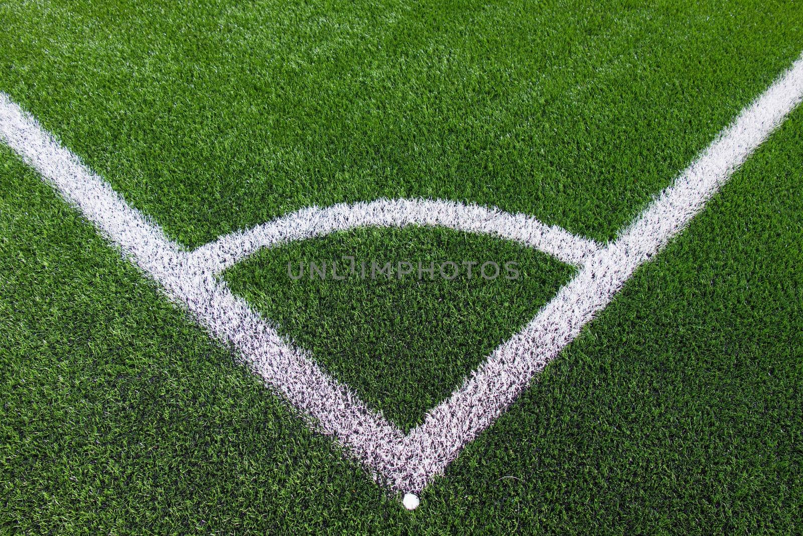 White corner line on green football field