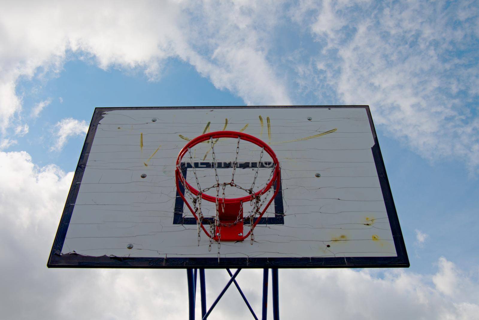 Old worn basketball hoopand  blue sky by rdonar2