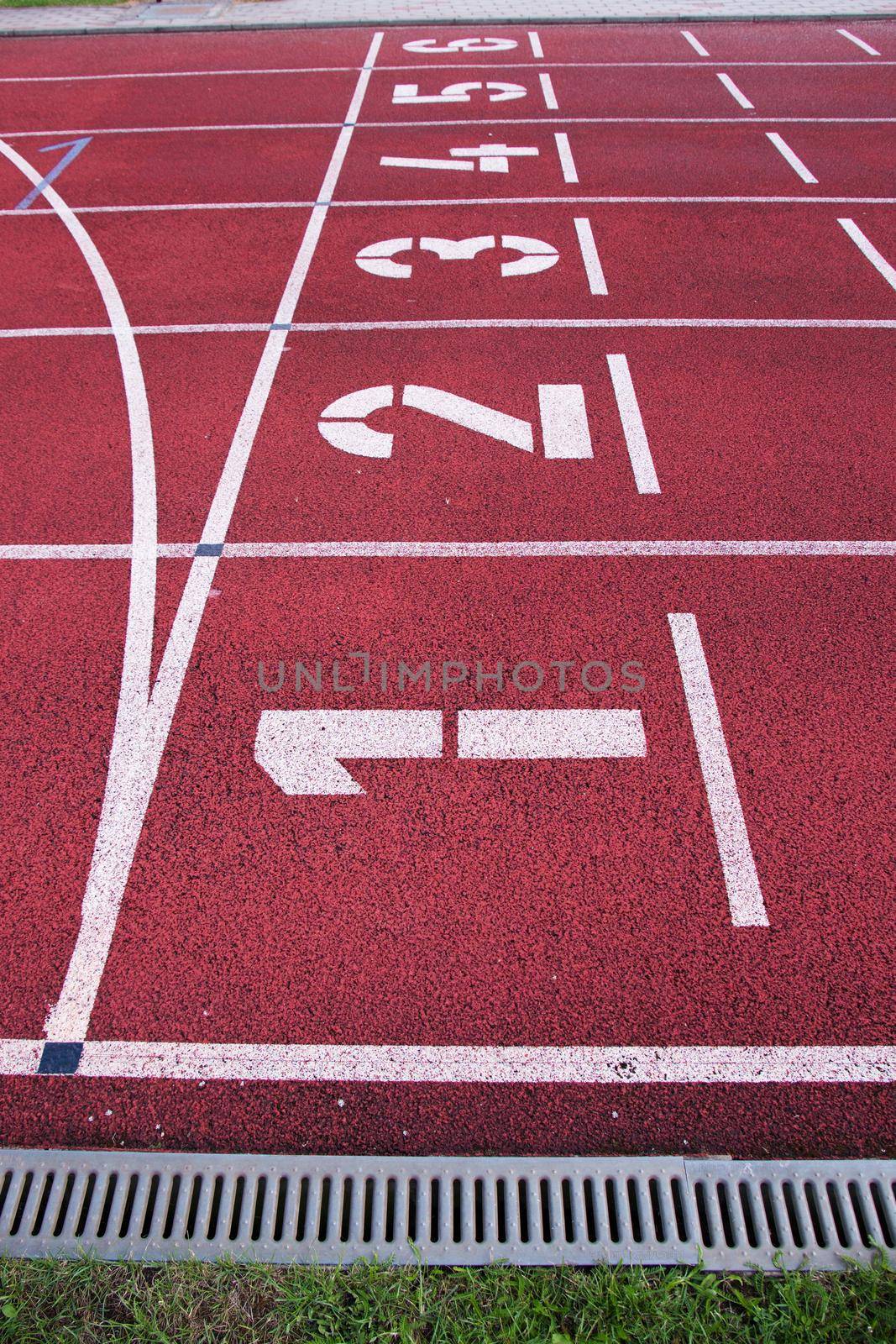 Red running racetrack on the athletic stadium by rdonar2