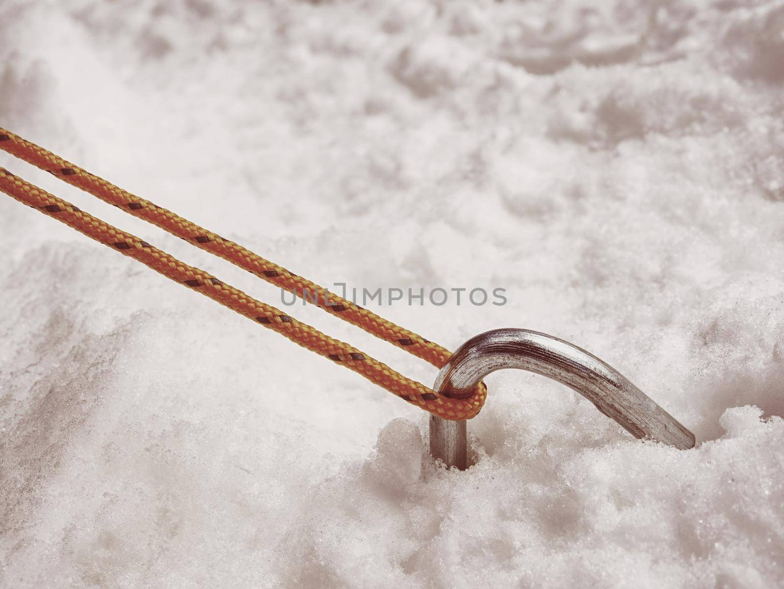 Chrome steel hook anchor camping tent in snow. Process of installing tent  by rdonar2