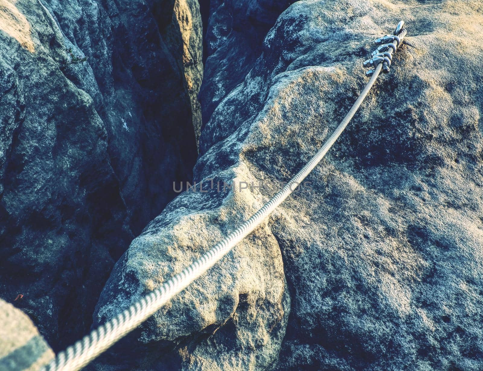 Srew with steel rope anchored into rocky wall by rdonar2