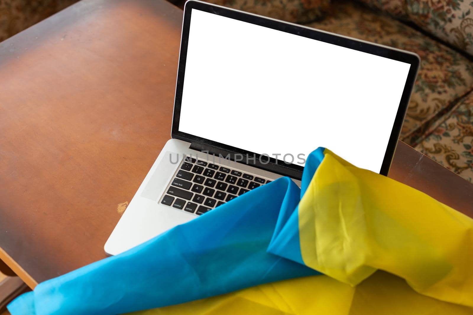 Mock-up laptop on ukrainian yellow-blue flag background. by Andelov13