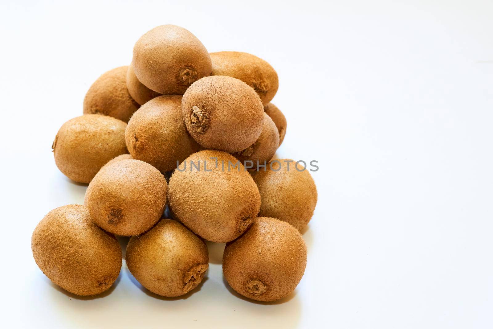 Bunch of ripe tasty sweet and sour kiwi fruit isolated on white background by jovani68