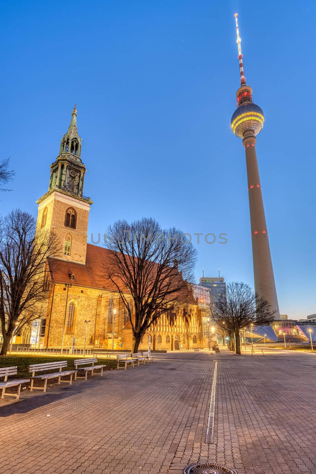 The famous TV Tower and the St. Mary's Church at the Alexanderplatz in Berlin at dawn