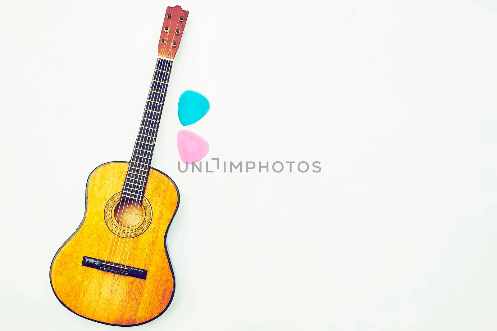 Wooden acoustic guitar two picks and space for text by jovani68