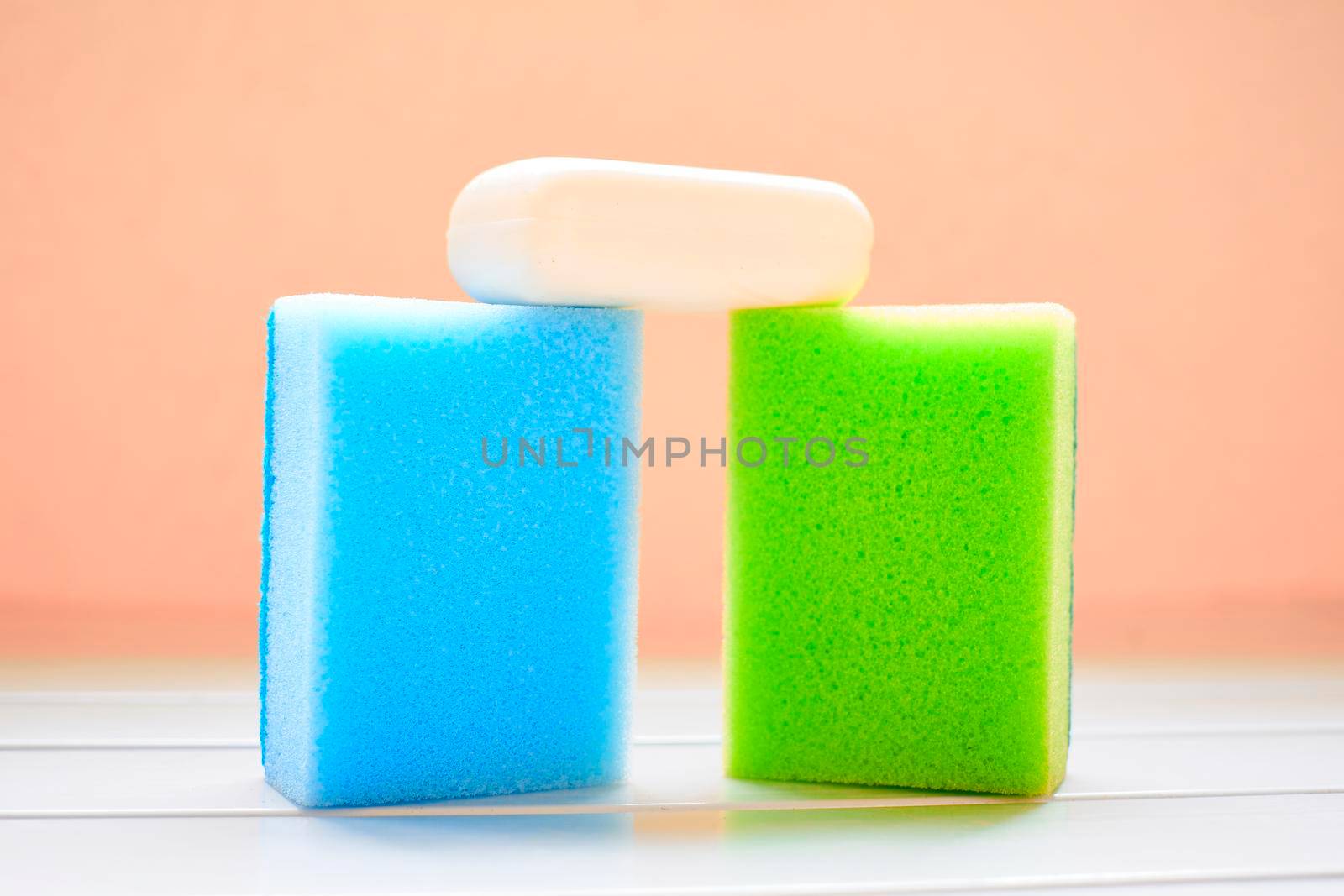 Two colored sponges and white soap for cleaning by jovani68